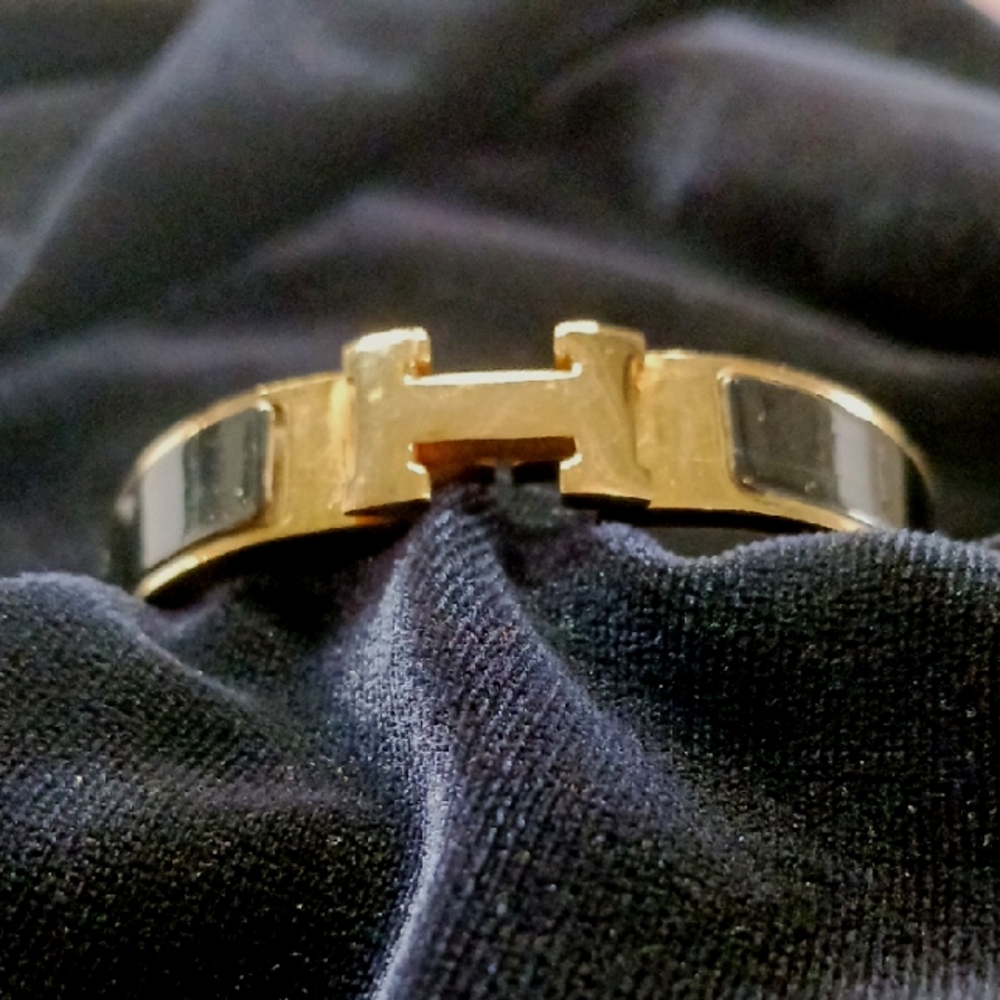 Hermes Blk Clic H With Gold Bracelet.